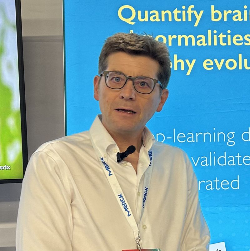 Dominic Shadbolt speaking at a conference on AI analysis of brain MRI